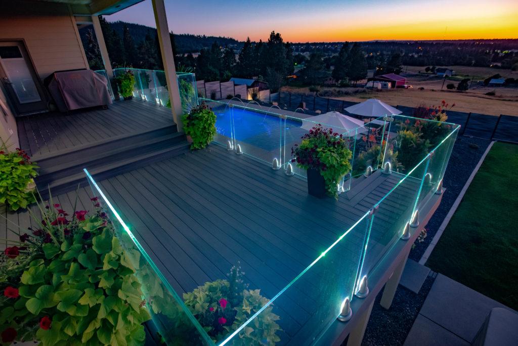 Large custom deck with glass regal railing in Spokane