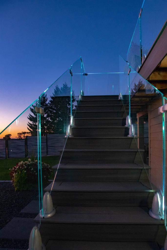 Custom deck in Spokane with Regal glass railing at sunset