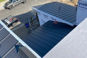 Black metal roof with a standing seam.